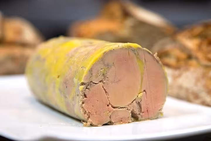 Close-up of traditional foie gras pâté on a white plate, a delicacy featured in Bordeaux private food tours.