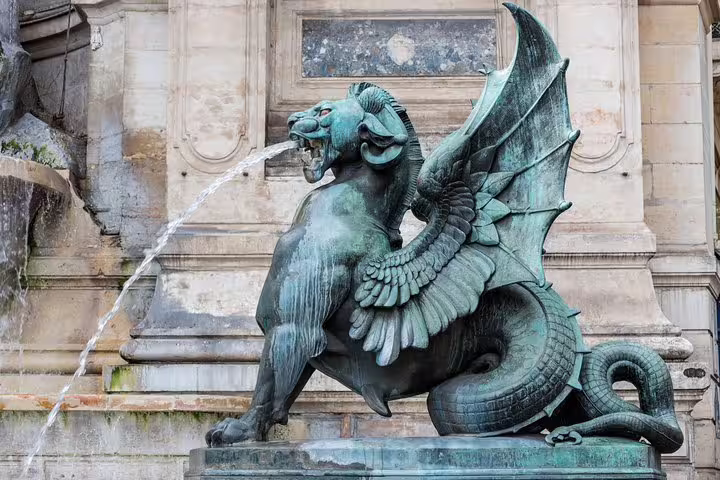 Winged dragon statue at Fontaine Saint-Michel, Paris, featured on the Highlights & Secrets of Paris Private Tour with Crêpes & Eiffel Tower.