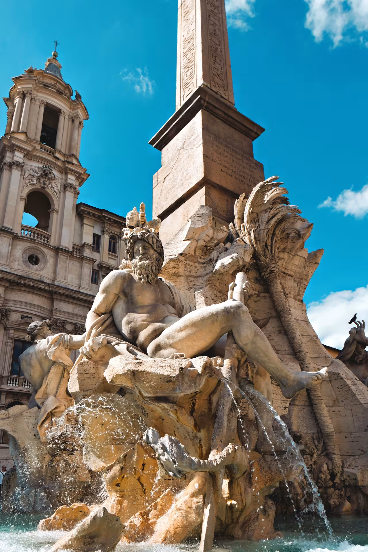 Stunning view of the Fontana dei Quattro Fiumi in Piazza Navona, Rome, featuring intricate sculptures and an obelisk.