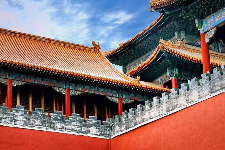 Majestic red and gold buildings of the Forbidden City under a clear sky, epitomizing imperial architecture in China.