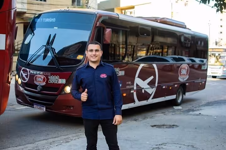 Driver with executive shuttle bus for transfer from Fortaleza Airport to Orla Marítima beachfront hotels