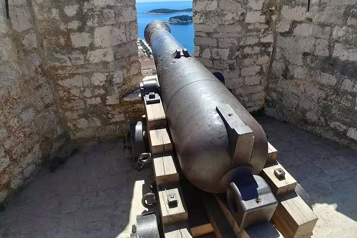 Historic cannon at Fortica Fortress, Hvar, overlooking Adriatic islands on a private boat tour day trip