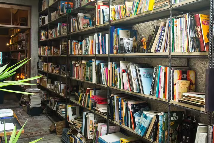 Cozy library setting with wooden shelves filled with colorful books, creating an inviting atmosphere for a wine tasting experience.