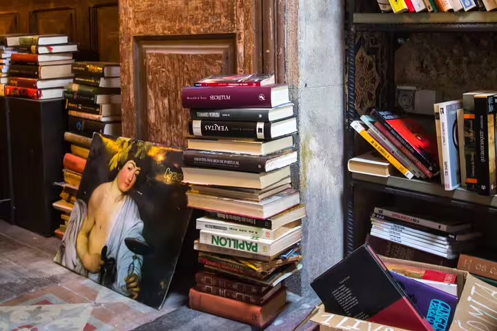 Cozy wine tasting venue with stacks of books and art, perfect for a unique fortified wine experience in a rustic setting.