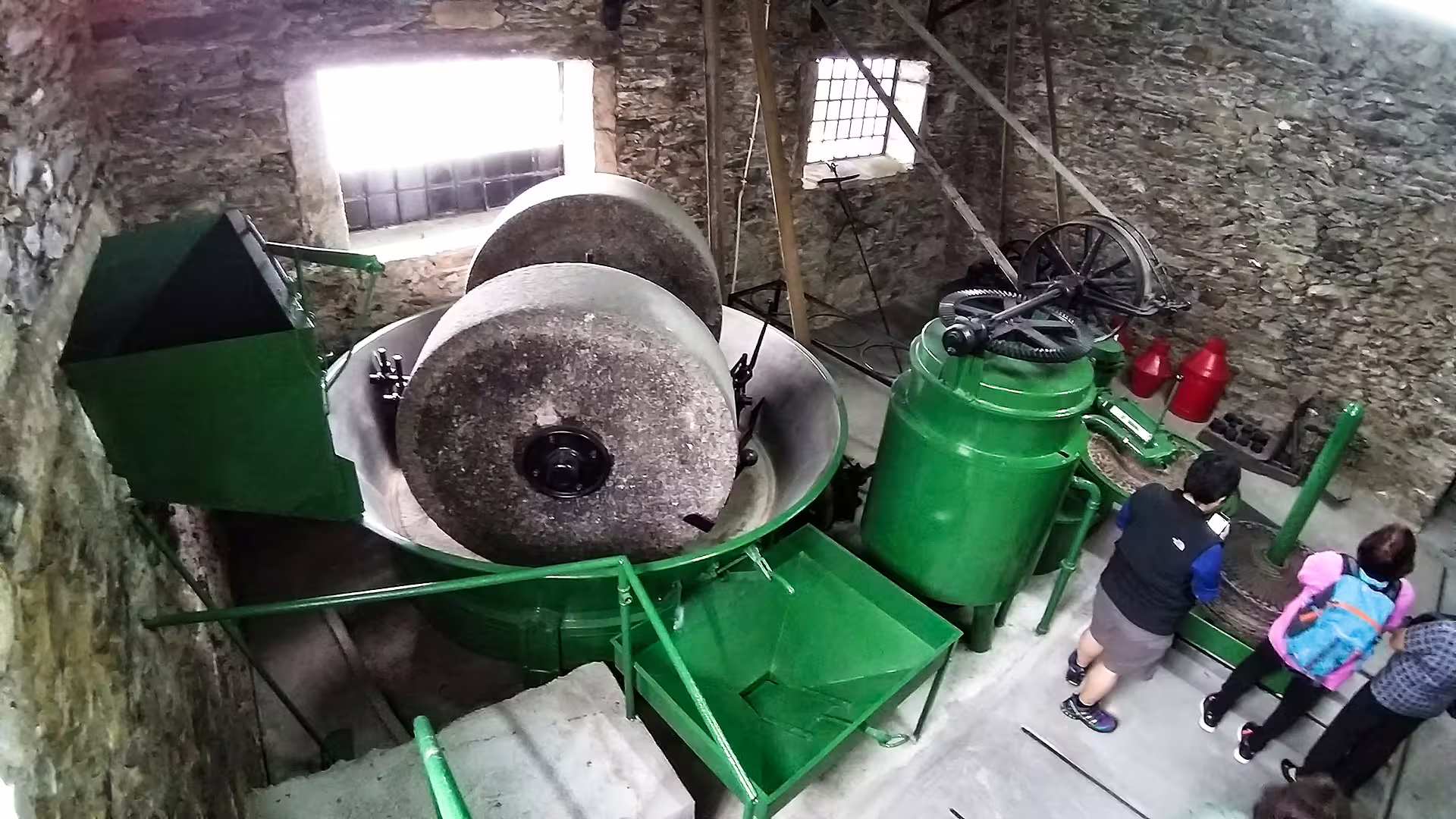 Visitors explore a traditional olive oil mill on the Foz Côa and Douro private tour, highlighting cultural heritage and artisanal craft.