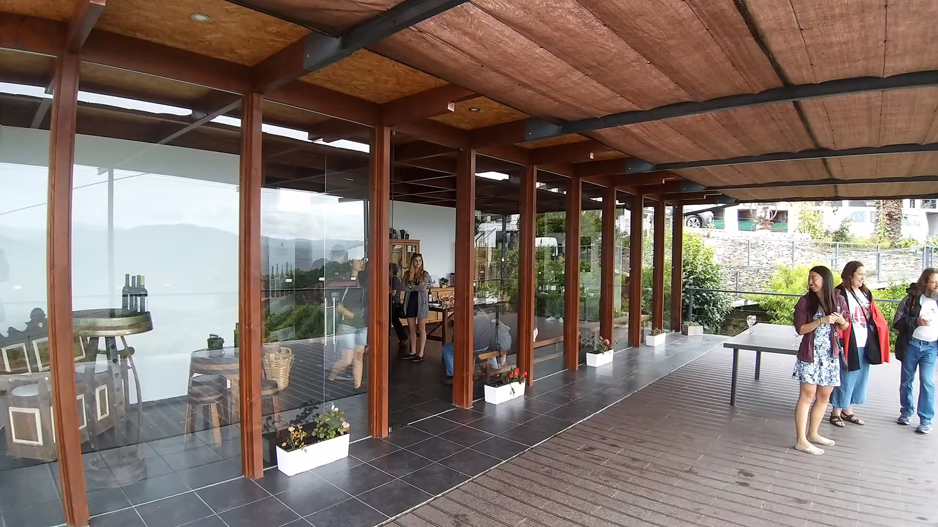 Visitors enjoying a modern vineyard terrace with panoramic views on the Foz Côa and Douro Private Tour, highlighting wine tasting.
