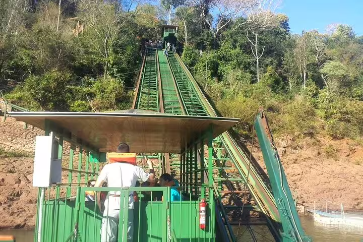 Visitors ascend a scenic incline railway at Foz do Iguaçu, offering panoramic views on a private tour experience.
