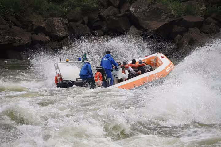 Adventure seekers enjoy a thrilling boat ride through the rapids at Foz do Iguaçu during a private tour.
