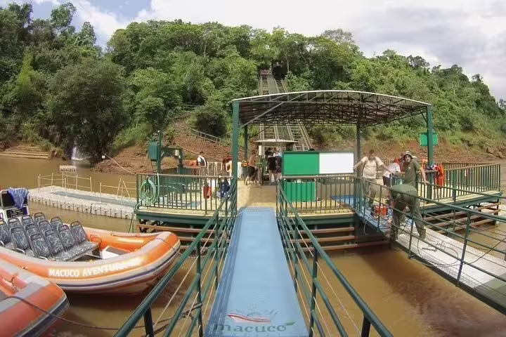 Dock with boats ready for an adventurous river tour in Foz do Iguaçu, surrounded by lush greenery and wildlife.