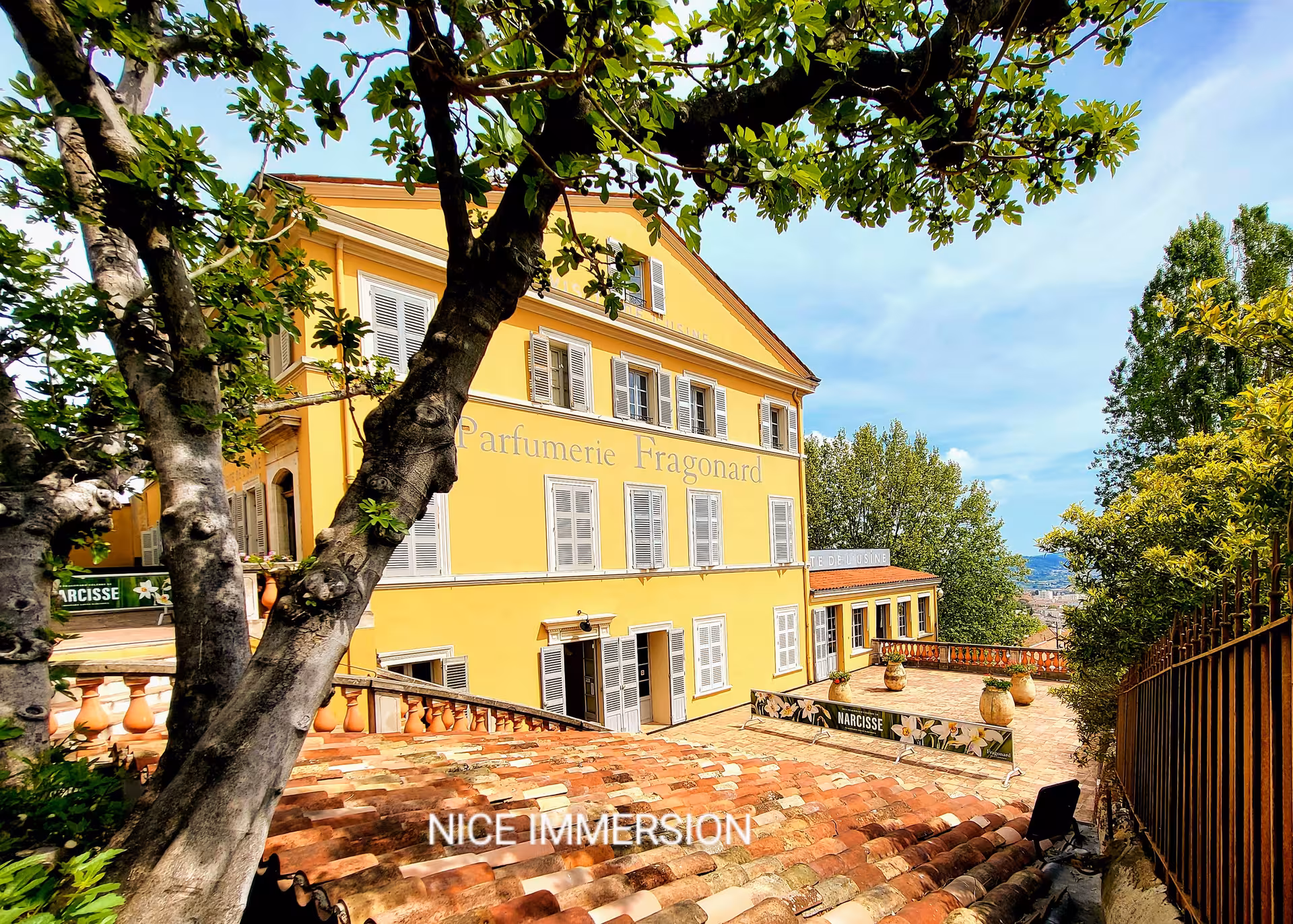 Historic Parfumerie Fragonard building nestled among trees on the charming French Riviera, offering a cultural immersion.