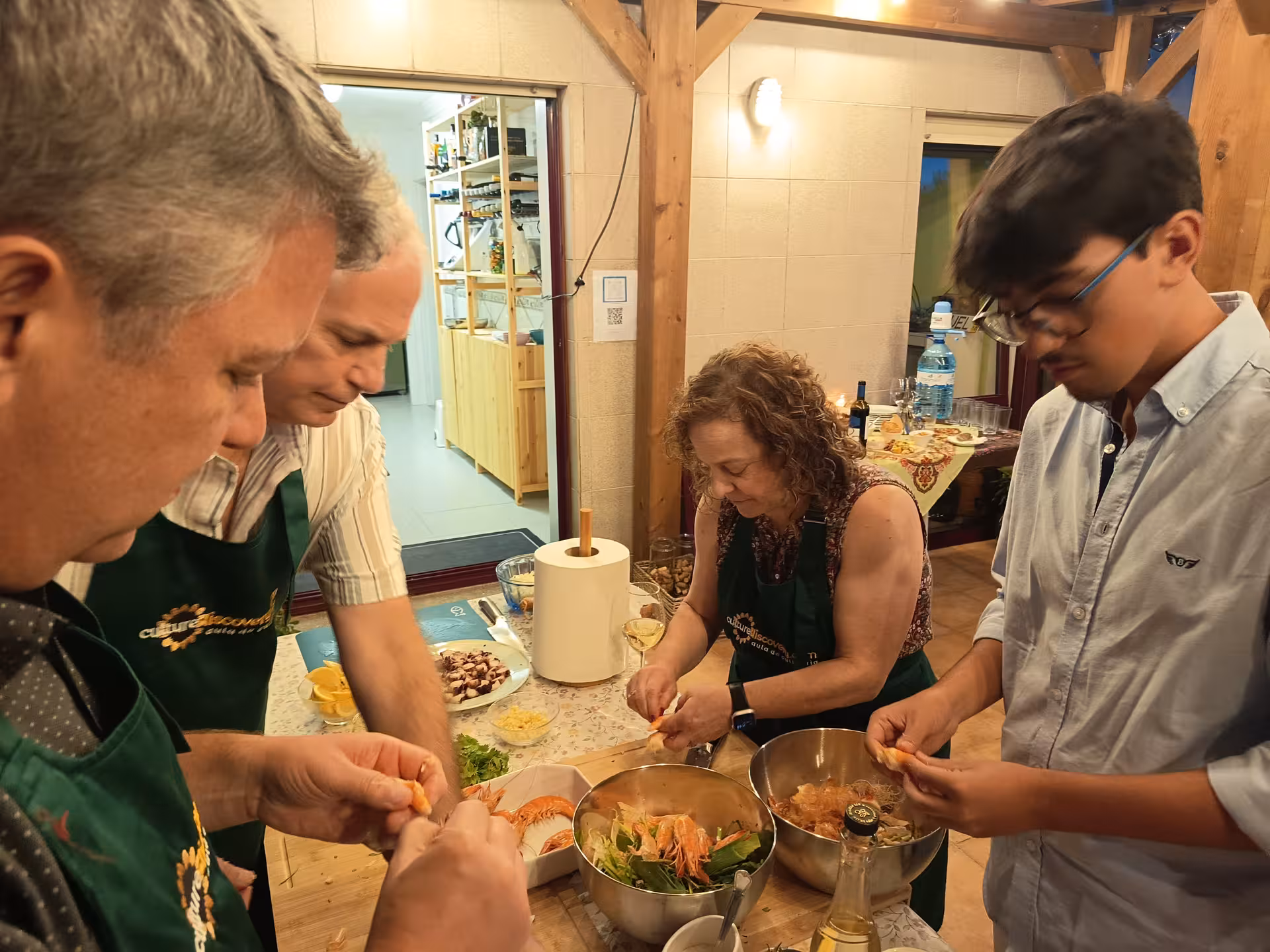 Group of people preparing ingredients for Francesinha in Porto cooking class, creating authentic Portuguese flavors.