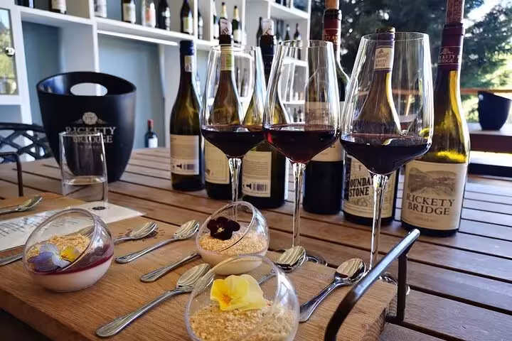 Elegant wine tasting setup with glasses and desserts at a Franschhoek winery, part of the Blue Line tour from Cape Town.