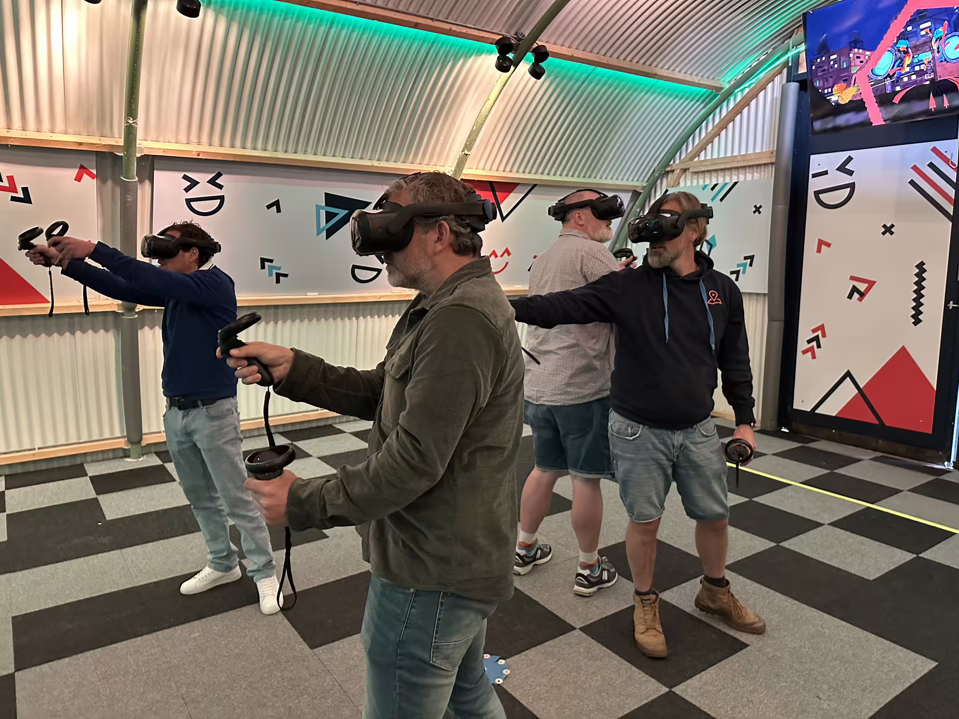 Visitors using VR headsets and controllers at the free Roam VR Experience in Amsterdam immersive arena
