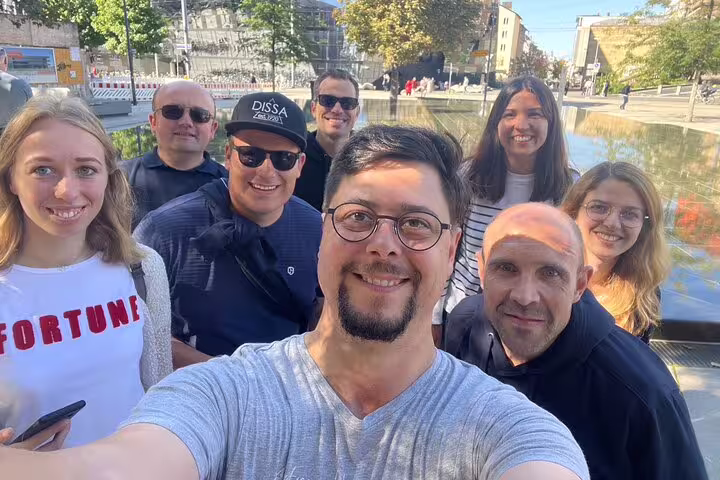 Friends selfie by Freiburg canal during a self-guided scavenger hunt tour exploring city sights and landmarks