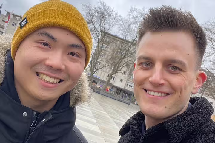 Friends smiling in Freiburg city center during a self-guided scavenger hunt and sightseeing walking tour