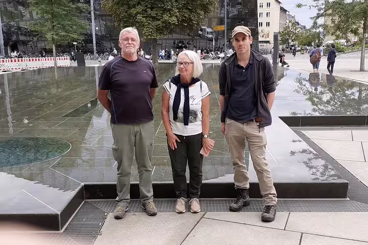 Group at Freiburg Old Synagogue Square memorial, exploring sights on a self-guided scavenger hunt tour