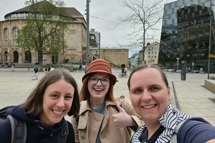 Friends on a Freiburg in Breisgau scavenger hunt selfie near the university area on a self-guided tour