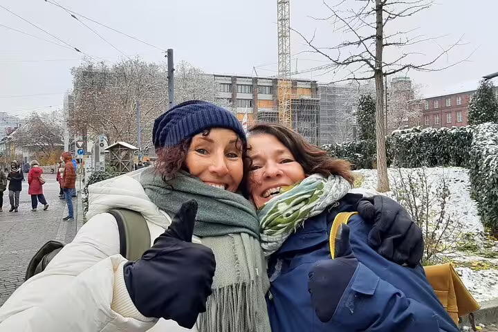 Friends bundled up in snowy Freiburg, enjoying a self-guided scavenger hunt walking tour in winter