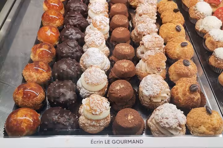 Assorted French pastries and choux buns at a Marseille bakery near Cours Julien and Noailles market tour