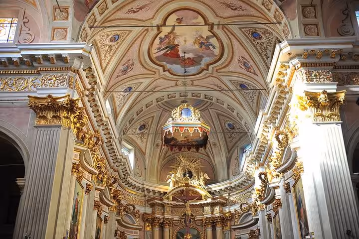 Stunning baroque church interior with intricate frescoes in the French Riviera, ideal for cultural exploration tours.
