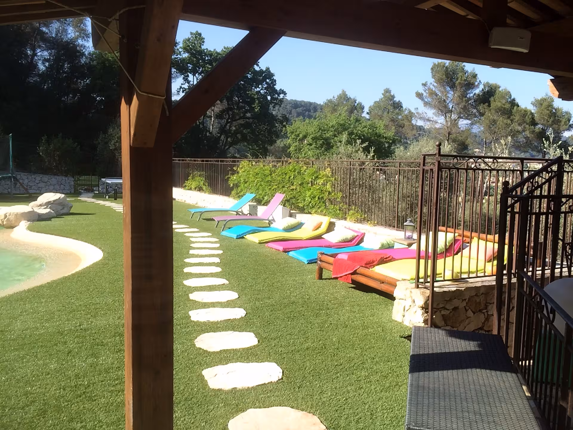 Relax by the colorful poolside with scenic views on the French Riviera getaway.