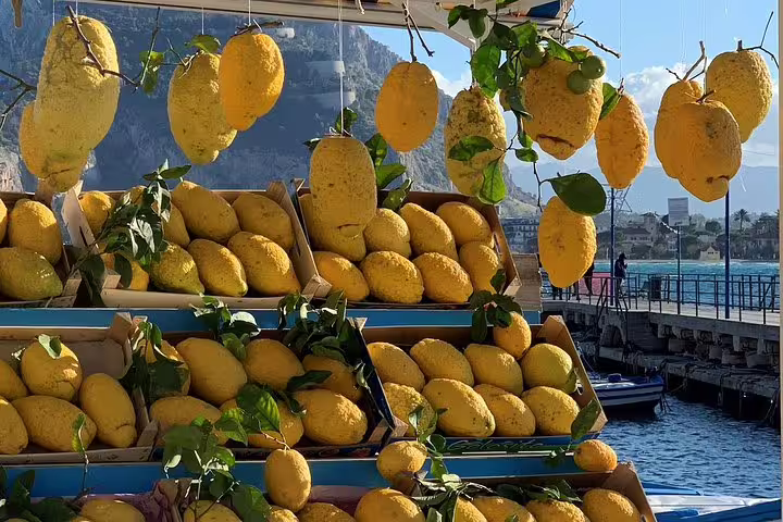 Fresh giant lemons at a seaside stall in Mondello near Palermo, Sicily, on a sunny day during a private coastal tour