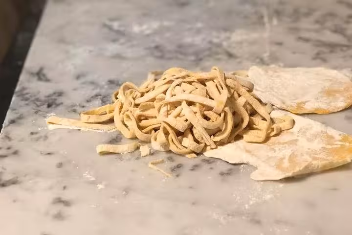 Freshly made pasta on a marble countertop during a market-to-table cooking class in Florence.