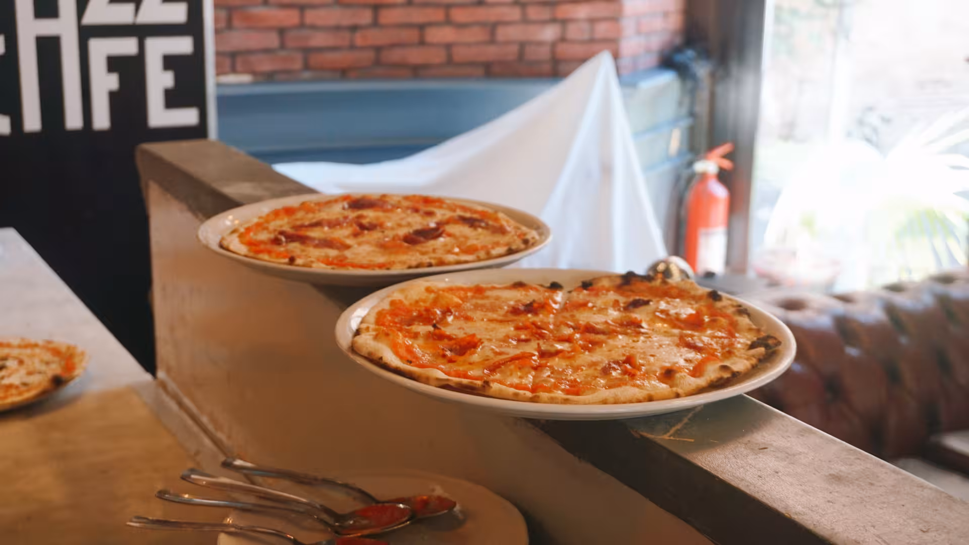 Freshly baked pizzas displayed at the Jazz Cafe during the Pizza Cooking Experience in Rome.