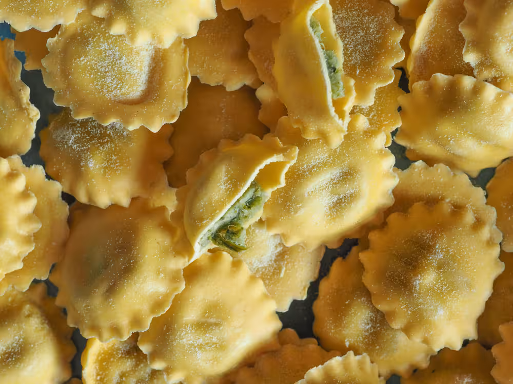 Close-up of freshly made ravioli pasta, showcasing the rich textures and colors of Italian cuisine.