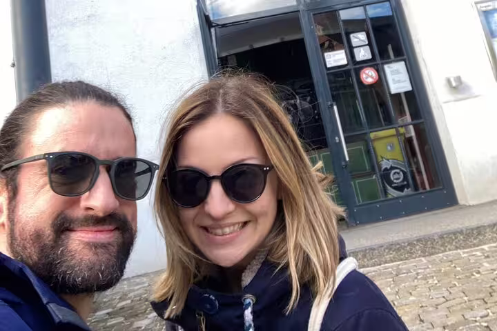 Couple selfie in Fribourg old town before a self-guided scavenger hunt tour, exploring top city sights
