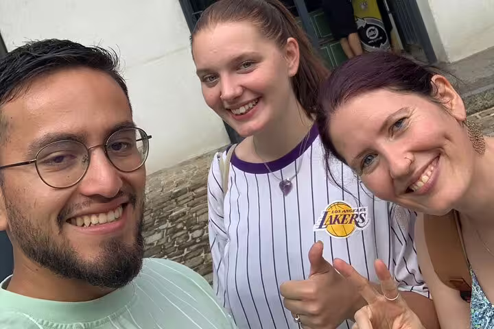 Smiling travelers on a Fribourg self-guided scavenger hunt tour, exploring historic sights in Switzerland