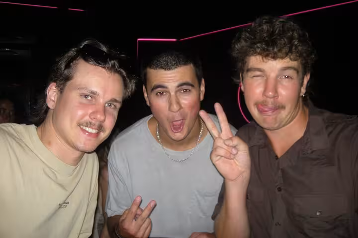 Three friends having fun at a Barcelona nightclub, highlighting the exciting and social nightlife scene.
