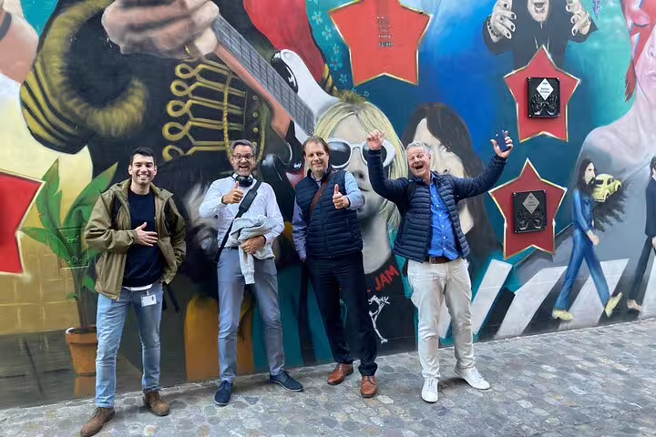 Friends pose at Basel rock mural stop on a self-guided scavenger hunt and sights walking tour experience