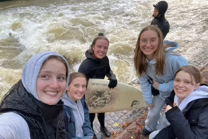 Friends by Eisbach wave in Munich, perfect stop on a self-guided scavenger hunt and sights tour