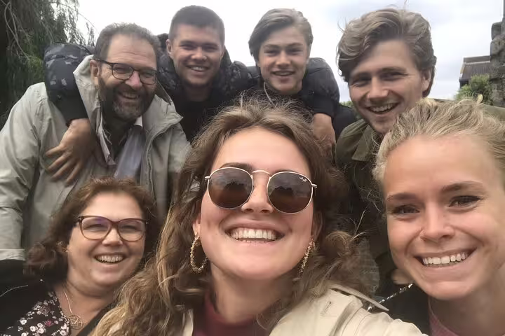 Friends smiling during an e-scavenger hunt in Arlon, Belgium, exploring landmarks with a self-guided app