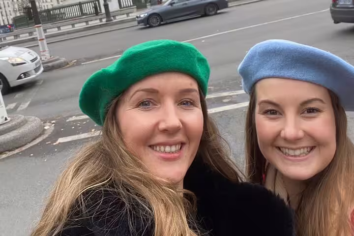 Friends in berets on Paris street, exploring Marais District via scavenger hunt and self-guided tour