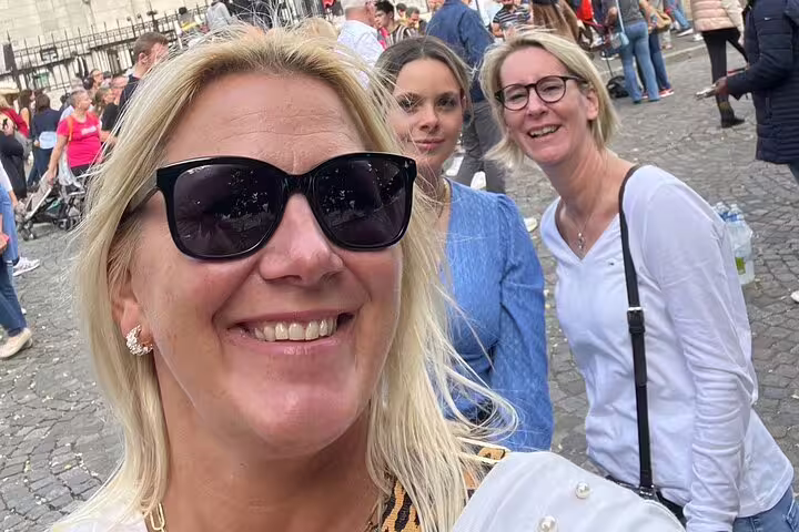 Friends smiling in Montmartre near Sacré-Cœur, Paris, during a self-guided scavenger hunt and sights tour
