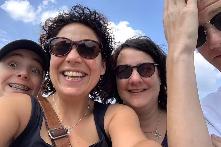 Friends smiling on a sunny day during a Montpellier e-scavenger hunt, self-guided city tour adventure