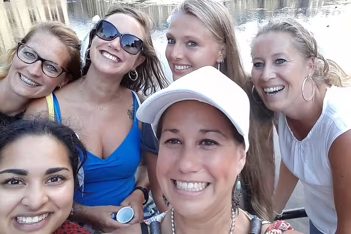 Friends smiling by the water while playing the Montpellier e-scavenger hunt, self-guided city exploration