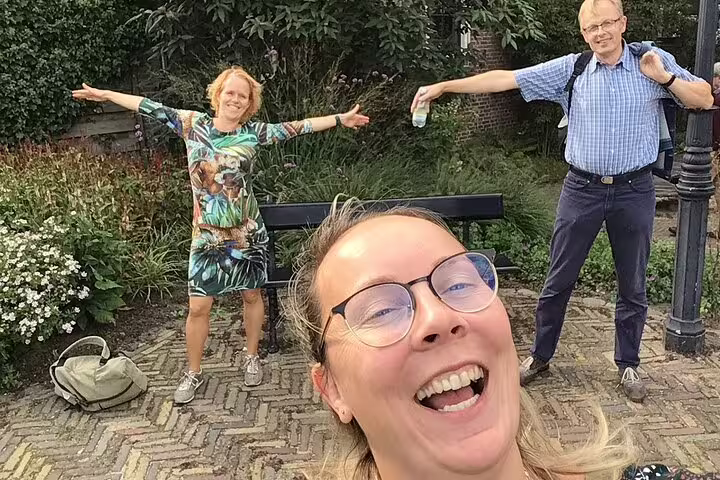 Friends taking a selfie during a Krakow e-scavenger hunt, enjoying a relaxed, self-guided city exploration