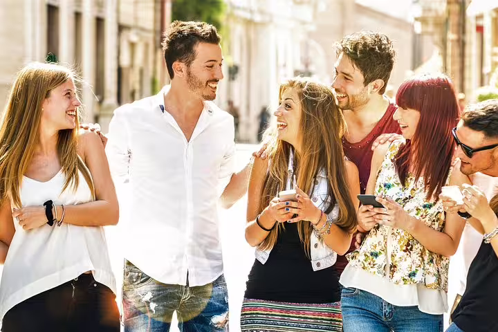 Friends using smartphones on an Antwerp street during a self-guided e-scavenger hunt city exploration game