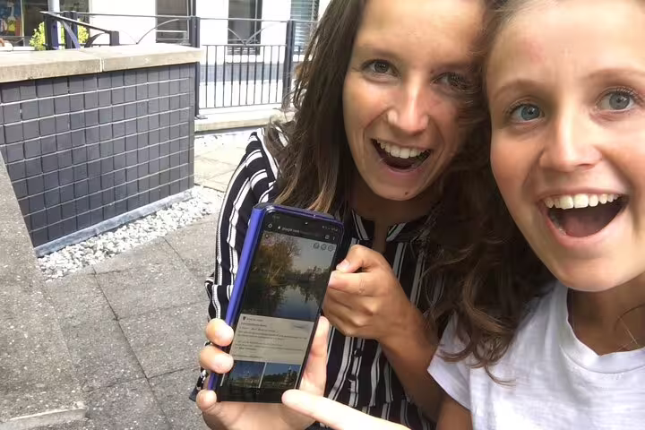 Friends using a smartphone for the Dublin e-scavenger hunt, solving clues on a self-paced city exploration