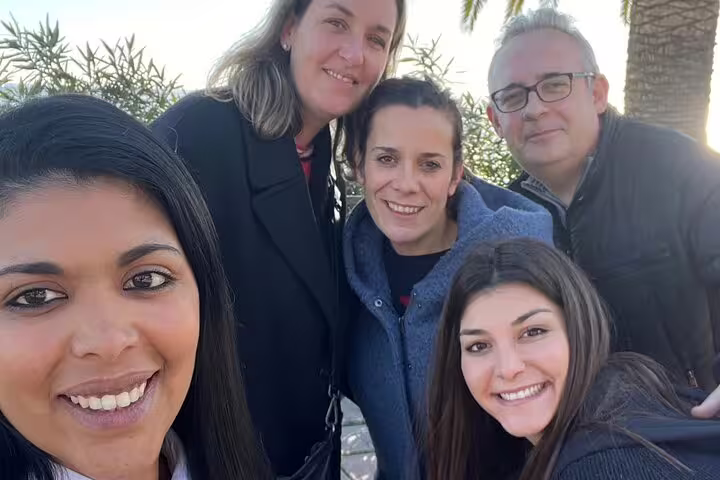 Friends smiling on a Tarragona scavenger hunt self-guided tour, exploring scenic city viewpoints