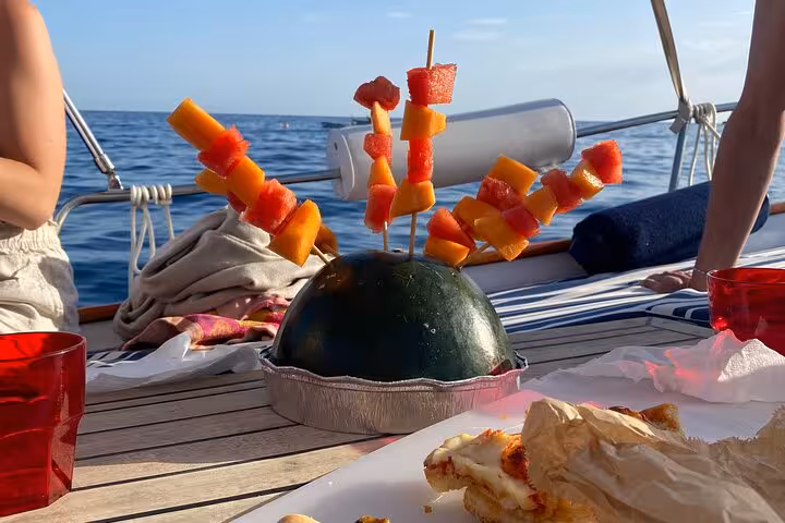A colorful fruit skewer arrangement on a boat deck, offering a delightful snack during a La Spezia sailing tour.