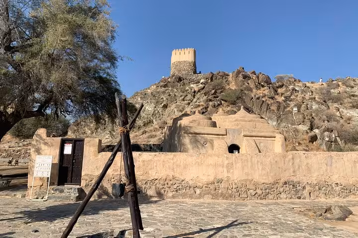 Rocky hilltop fort and courtyard in Fujairah on Khorfakkan tour, scenic museum visit and local heritage