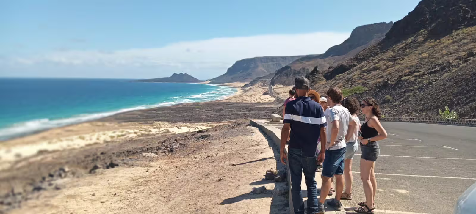 Tourists enjoy breathtaking coastal views during a full day island tour in São Vicente, Mindelo, showcasing stunning landscapes.