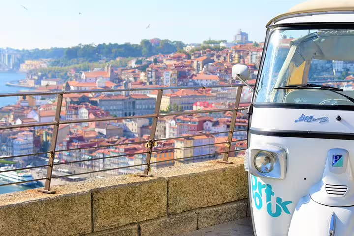 Tuk Tuk overlooking scenic Porto cityscape, ideal for private full-day tour exploring historic sites and vibrant culture.