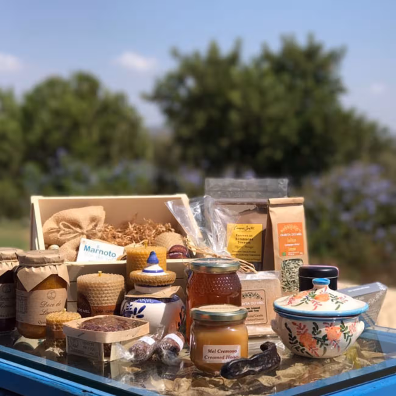 Local honey, herbal teas and regional delicacies displayed outdoors, included tasting stop on the full day quad tour