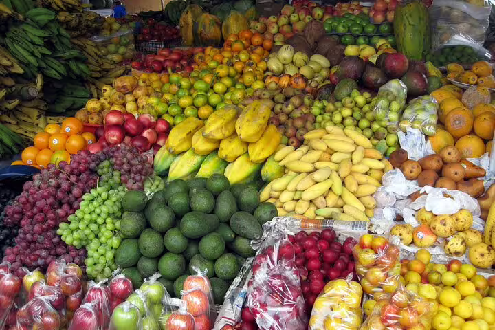 Vibrant display of fresh fruits at a local farmers market in Funchal, perfect for a 4WD tour experience.