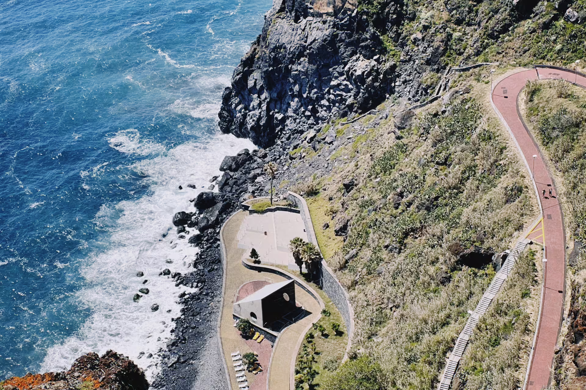 Scenic coastal view from Funchal to Garajau on a self-guided e-bike tour, featuring winding paths and stunning ocean cliffs.